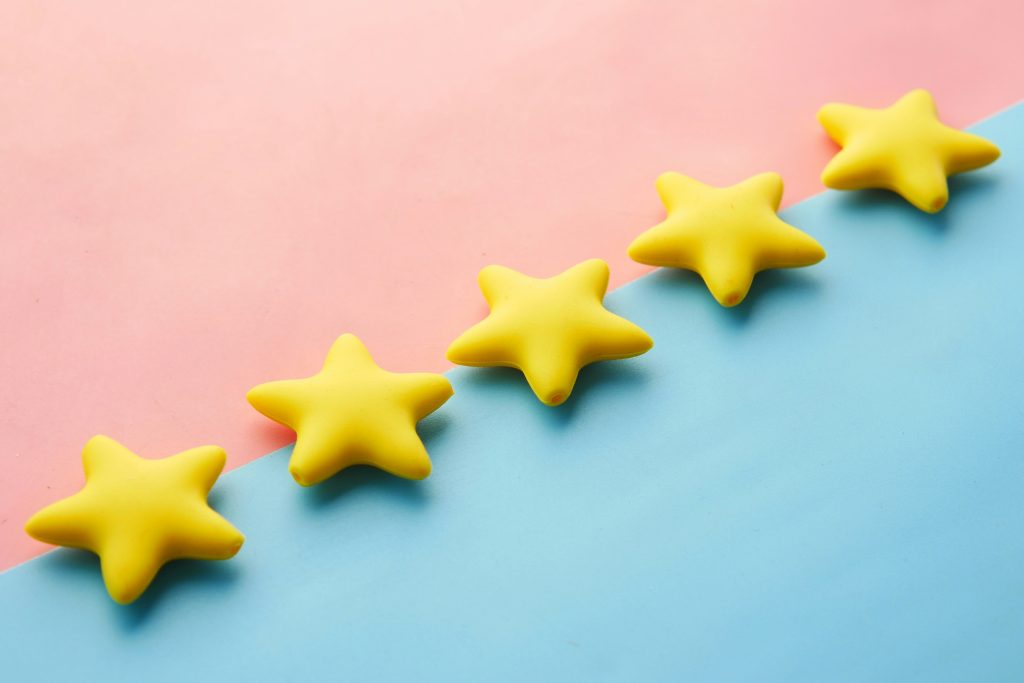 Yellow stars on a colorful surface representing star ratings and reviews
