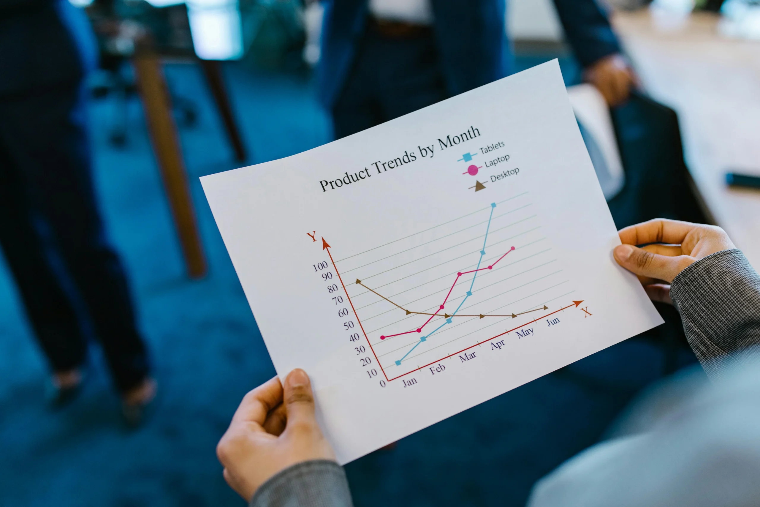 Close-up of hands holding a product trend chart representing micro-content marketing strategy for digital product launches