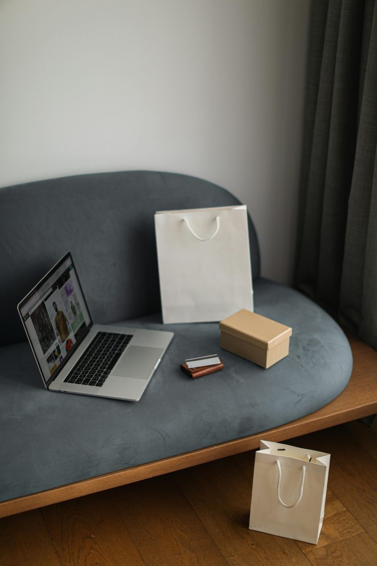 Ecommerce scene with laptop and shopping bags representing AI product listing tools
